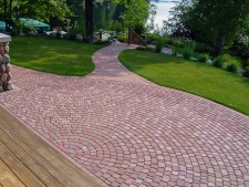 Radial red brick pattern patio with matching walkway