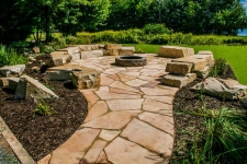 Fire pit in middle of stone slab ground and rock seating